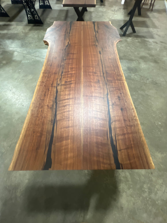 Live edge walnut wood slab with rich dark grain and natural edges.