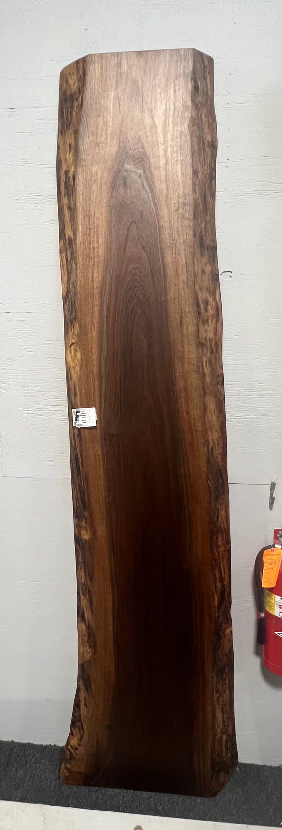 Live edge walnut wood slab with rich dark grain and natural edges.
