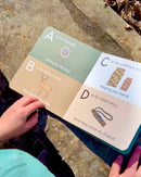 Children's book with alphabet cards on a stone surface