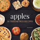 Cover of the 'Apples: 50 Tried & True Recipes' cookbook by Julia Rutland, featuring an array of apple-related dishes and whole apples on a dark background.