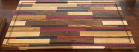 Wooden cutting board with a multicolored pattern on a wooden surface
