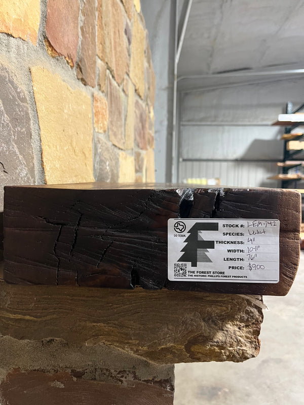 Live Edge Walnut Fireplace Mantel with a white label, featuring a natural wood grain and smooth finish, ideal for complementing white stone fireplaces.