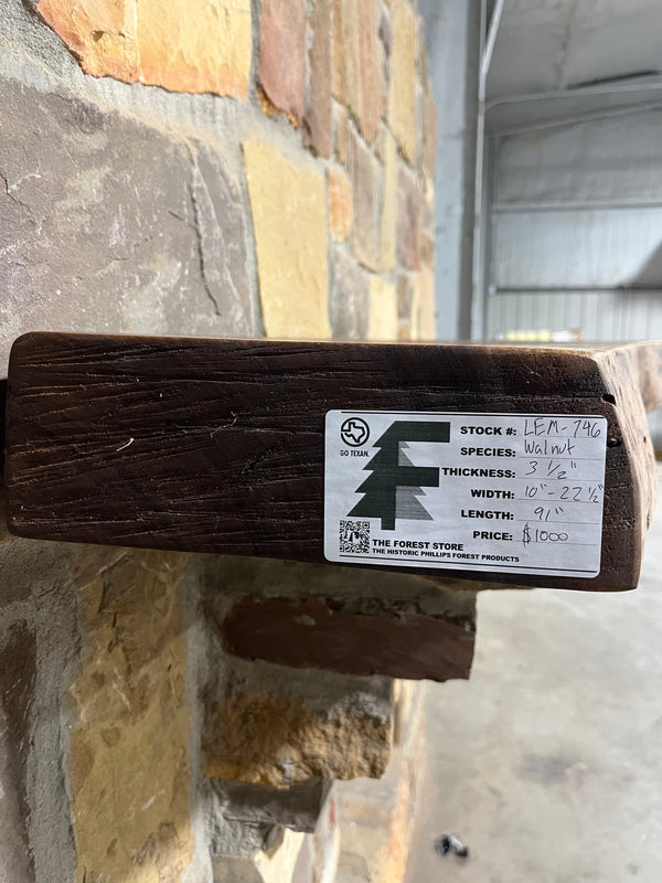 Rustic end of walnut mantel containing the label of the forest store