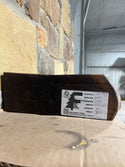 Rustic end of a circle sawn, live edge walnut mantel containing the forest store's label