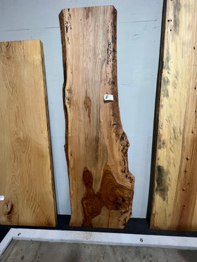 Live edge pecan slab with rich golden-brown tones, natural grain patterns, and organic edges