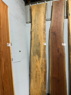 Finished live edge blue pine slab with natural grain and blue-gray streaks
