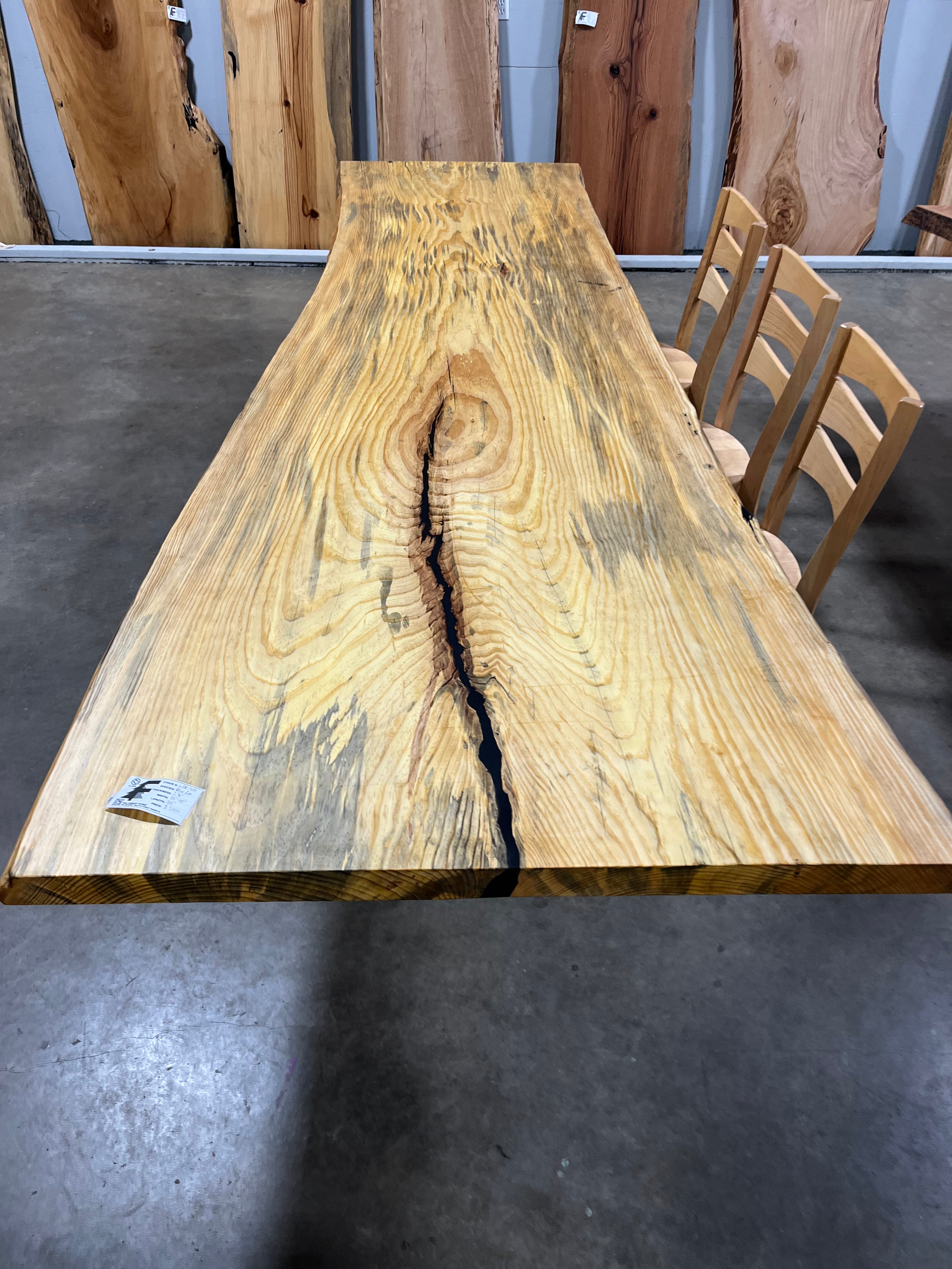 Finished live edge blue pine slab with natural grain and blue-gray streaks
