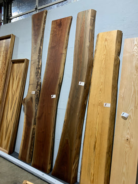 Live edge walnut wood slab with rich dark grain and natural edges.
