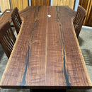 Live edge walnut wood slab with rich dark grain and natural edges.
