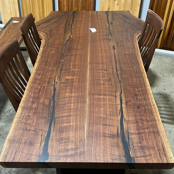 Live edge walnut wood slab with rich dark grain and natural edges.
