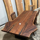 Live edge walnut wood slab with rich dark grain and natural edges.
