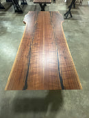 Live edge walnut wood slab with rich dark grain and natural edges.
