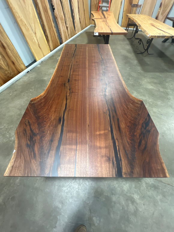 Live edge walnut wood slab with rich dark grain and natural edges.
