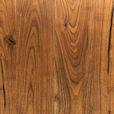 Close-up view of a piece of american walnut lumber displaying its wood grain.