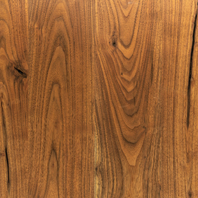 Close-up view of a piece of american walnut lumber displaying its wood grain.