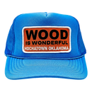 A blue trucker hat with a Wood is Wonderful Hochatown Oklahoma patch