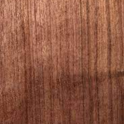Close-up view of a piece of bubinga lumber displaying its wood grain.
