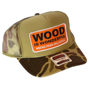 A camo trucker hat with a Wood is Wonderful Hochatown Oklahoma patch