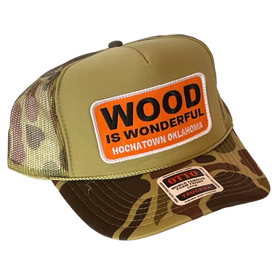 A camo trucker hat with a Wood is Wonderful Hochatown Oklahoma patch