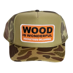 A camo trucker hat with a Wood is Wonderful Hochatown Oklahoma patch