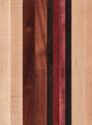 A striped cutting board made of various wood shades, including light beige and darker brown, with a smooth surface.
