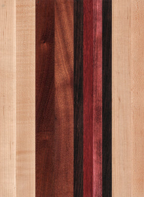 A striped cutting board made of various wood shades, including light beige and darker brown, with a smooth surface.