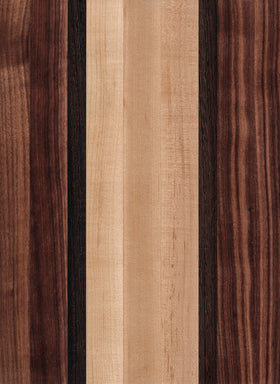 A wooden cutting board with a striped pattern of different shades of brown and beige.