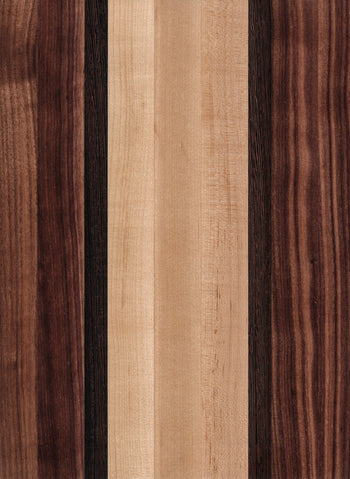 A wooden cutting board with a striped pattern of different shades of brown and beige.