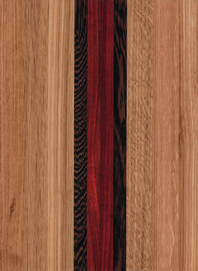 A wooden cutting board with a pattern of different wood shades and an engravable state outline.
