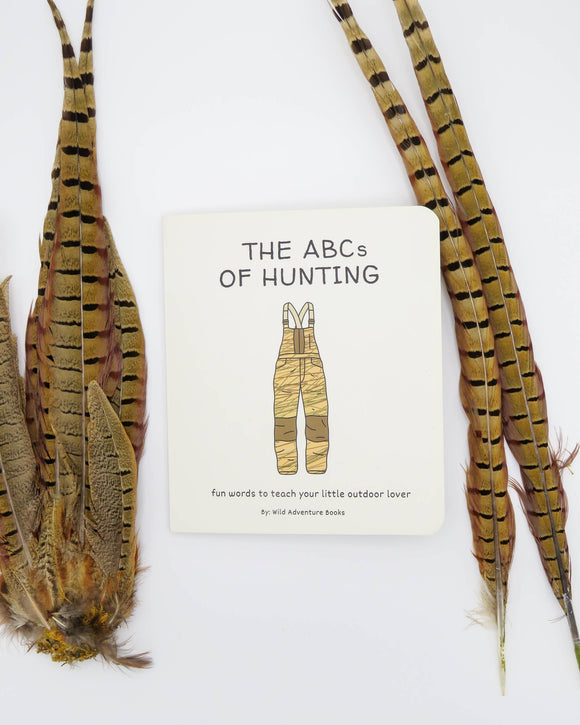 Book titled 'The ABCs of Hunting' with feathers on a white background