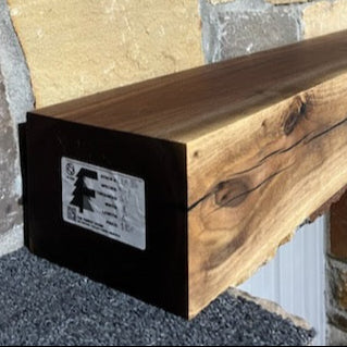 A beam style fireplace mantel, made from walnut wood, displayed on a rack.