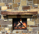 A beam style fireplace mantel, made from walnut wood, displayed on a rock wall.