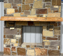 Solid live edge ash fireplace mantel mounted on a stone wall.