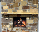 A live edge style fireplace mantel, made from ash wood, mounted on a stone wall.