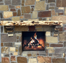 A live edge style fireplace mantel, made from cedar wood, mounted on a stone wall.
