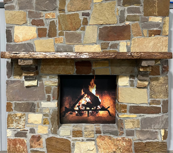 A live edge style fireplace mantel, made from cherry wood, mounted on a stone wall.