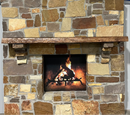 A live edge style fireplace mantel, made from cherry wood, mounted on a stone wall.
