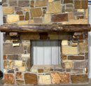 A live edge style fireplace mantel, made from walnut wood, mounted to a rock wall.