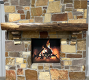 A live edge style fireplace mantel, made from walnut wood, mounted to a rock wall.