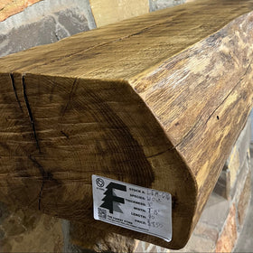 A live edge style fireplace mantel, made from white oak wood, mounted on a stone wall.