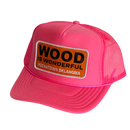 A hot pink trucker hat with a Wood is Wonderful Hochatown Oklahoma patch