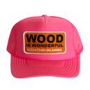 A hot pink trucker hat with a Wood is Wonderful Hochatown Oklahoma patch