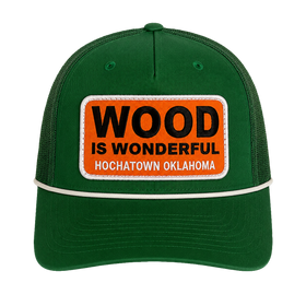 A kelly green hat with a Wood is Wonderful Hochatown Oklahoma patch