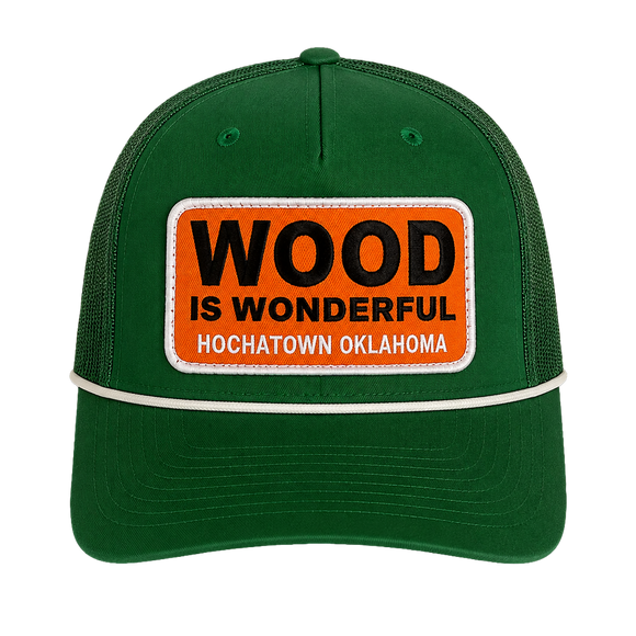 A kelly green hat with a Wood is Wonderful Hochatown Oklahoma patch