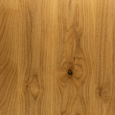 Close-up view of a piece of knotty alder lumber displaying its wood grain.