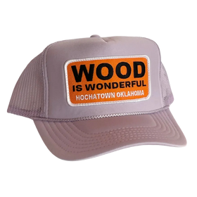A lavender trucker hat with a Wood is Wonderful Hochatown Oklahoma patch