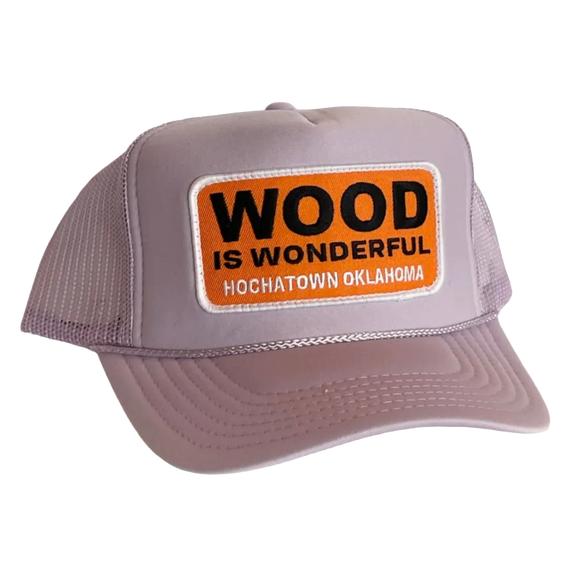 A lavender trucker hat with a Wood is Wonderful Hochatown Oklahoma patch