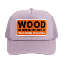 A lavender trucker hat with a Wood is Wonderful Hochatown Oklahoma patch