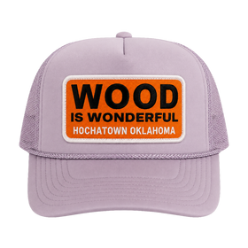 A lavender trucker hat with a Wood is Wonderful Hochatown Oklahoma patch