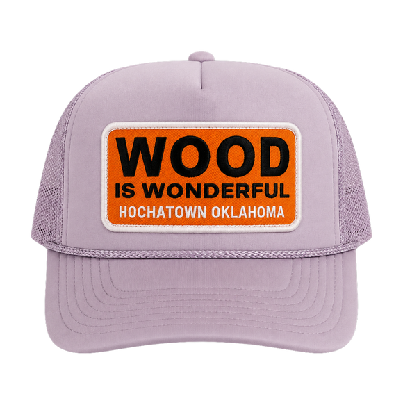 A lavender trucker hat with a Wood is Wonderful Hochatown Oklahoma patch